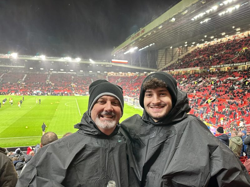 Tryfon and a companion in the stands at a football match