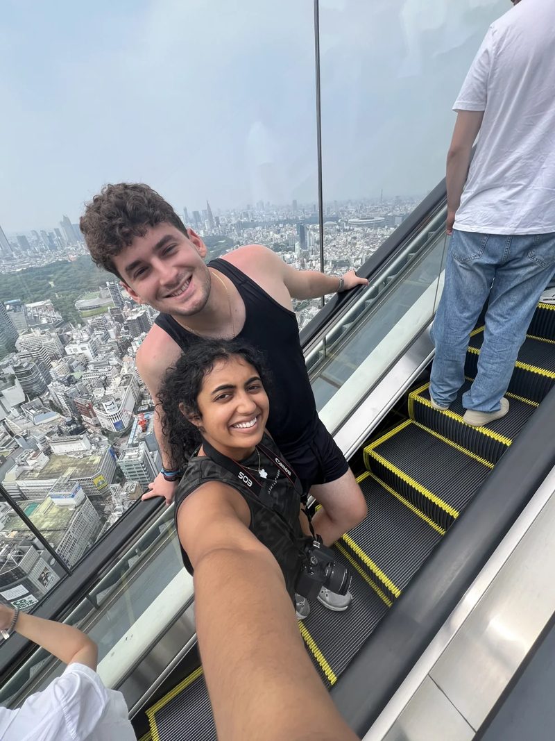 Tryfon and a companion above Tokyo with the city in the background