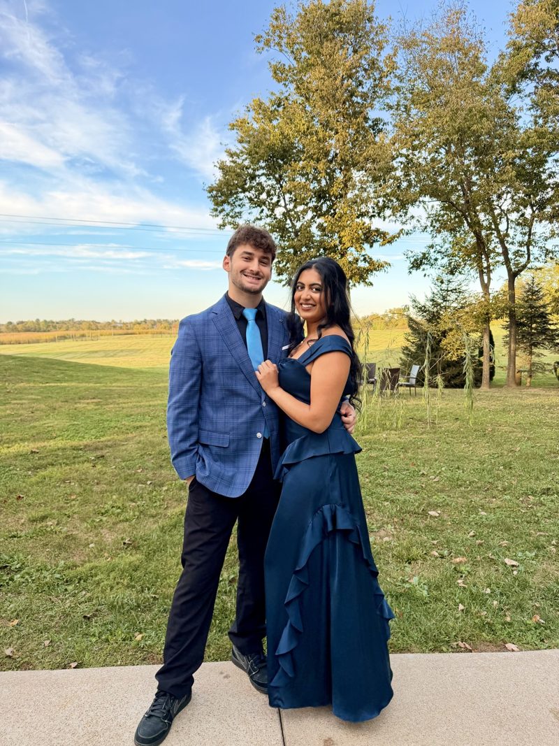 Tryfon and a companion dressed for a formal occasion outdoors