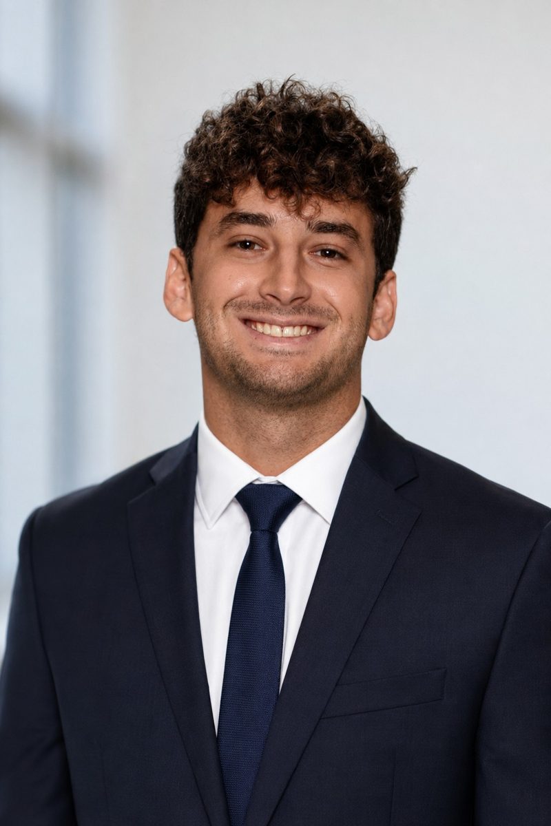 Tryfon Theophilopoulos wearing a navy suit and tie