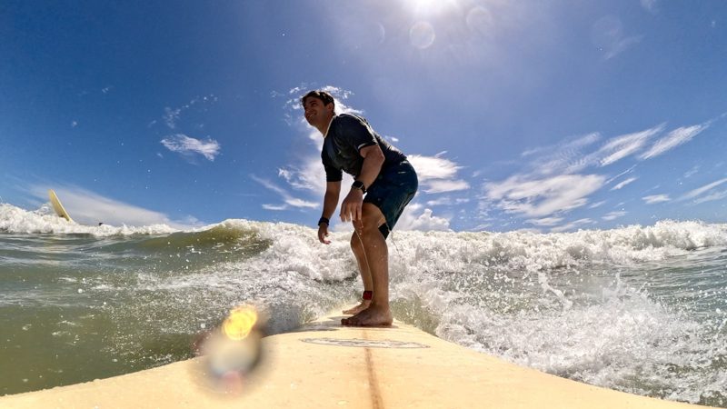 Tryfon riding a wave, photographed from the front of his surfboard